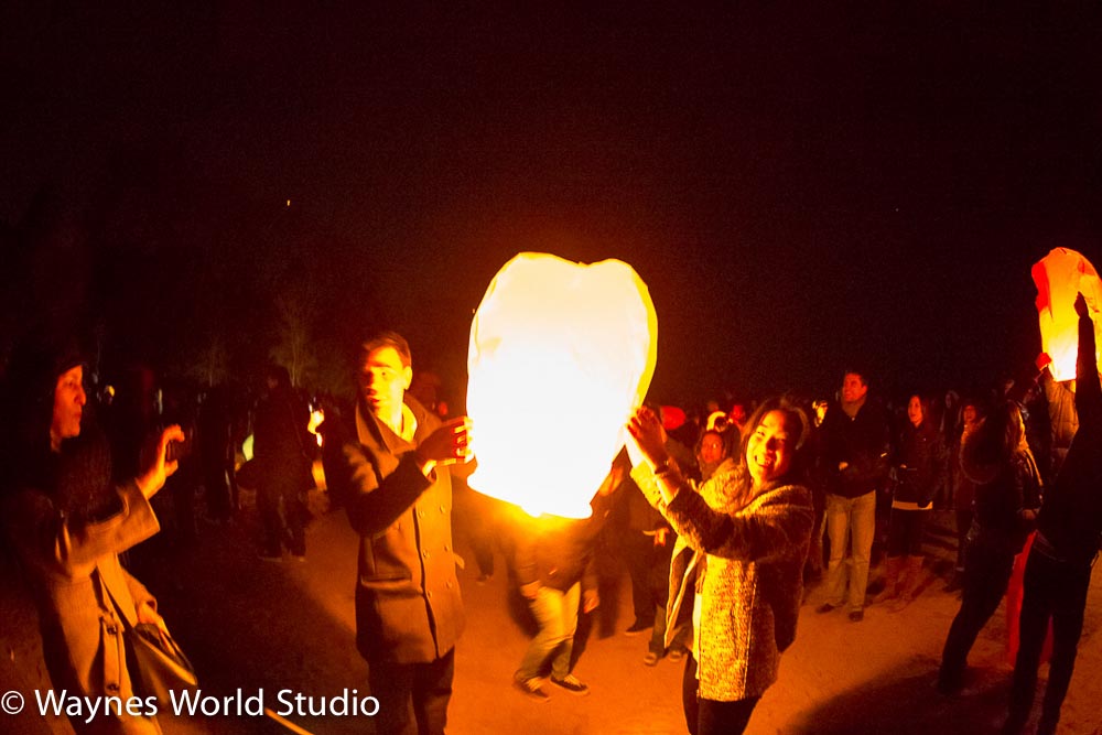 releases Chinese lantern with wishes and hope